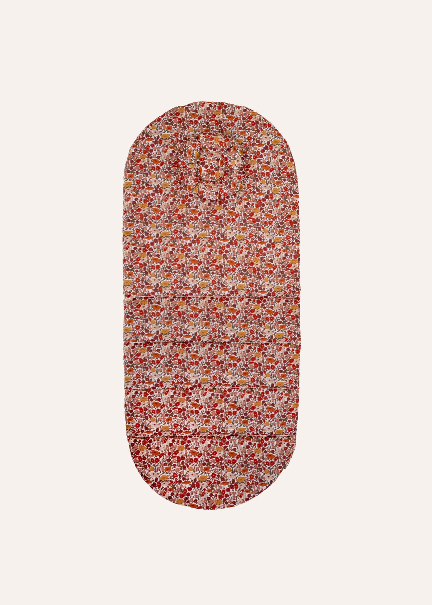 Ergonomic mat ErgoTopper in the Claire floral pattern in red, ochre, and rose, oval shape with head pillow