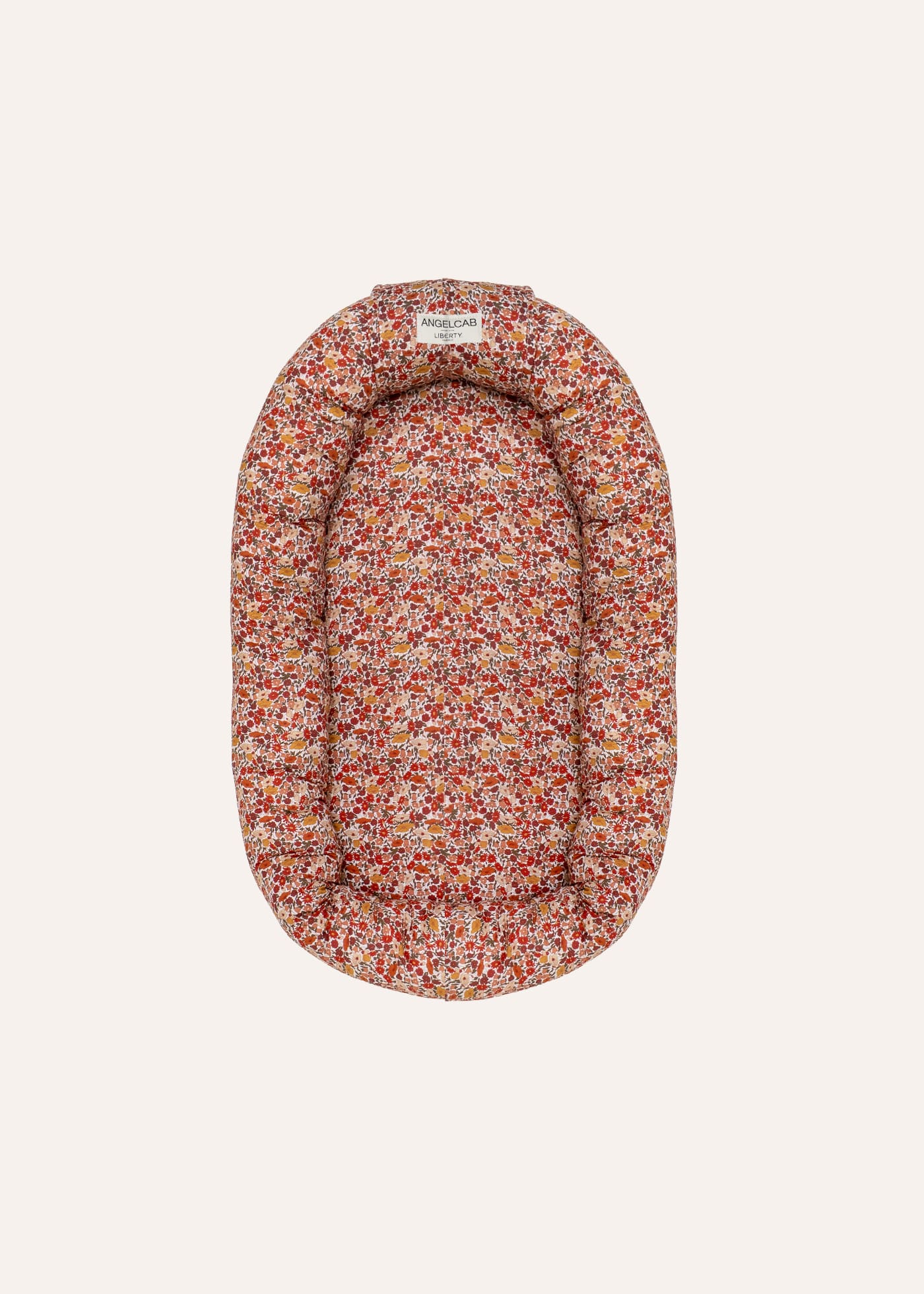 Babynest von ANGELCAB aus Liberty-Stoff Claire mit rotem Blumenmuster, ovale Form mit gepolstertem Rand